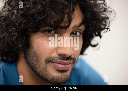 Confident technician with beard and curly black hair Stock Photo