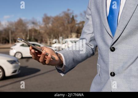 Businessman using smart phone on sunny day Stock Photo