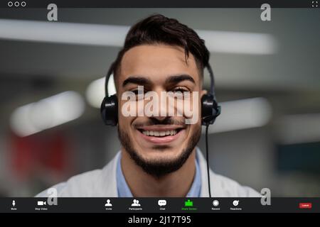Pov screen of handsome middle eastern doctor having video chat Stock Photo