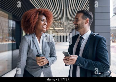 Two business colleagues talking outdoors Stock Photo
