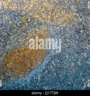 Abstract colour photograph of coastal rock the image is a colour abstract with a near impressionism style, containing rock patterns and textures. Stock Photo