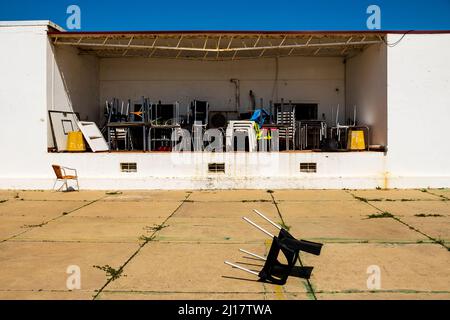 Pattern of messy chairs and tables in outdoor storage in Farol island, Algarve, Portugal Stock Photo