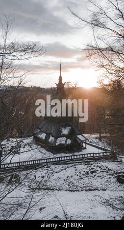 The facade of the Fantoft Stave Church in Bergen under a cloudy sky Stock Photo