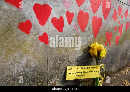 Flowers are seen at The National Covid Memorial Wall, on national day of reflection to mark the two year anniversary of the United Kingdom going into national lockdown, in London, Britain, March 23, 2022. REUTERS/Peter Cziborra