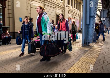 Lviv, Ukraine. 23rd Mar, 2022. People with their luggage walk to board the train. The Lviv train station continues to play a major roll in the evacuation of Ukrainians and bringing supplies into the country. (Photo by Ty ONeil/SOPA Images/Sipa USA) Credit: Sipa USA/Alamy Live News Stock Photo