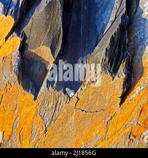 Abstract colour photograph of coastal rock the image is a colour abstract with a near impressionism style, containing rock patterns and textures in bl Stock Photo