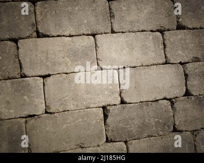 Gray stone brick wall suitable as background for text to create or design a poster, card, design or webpage background with a classic and rustic look. Stock Photo