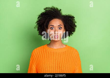 Photo of flirty millennial curly hairdo lady blow kiss wear orange pullover isolated on green color background Stock Photo