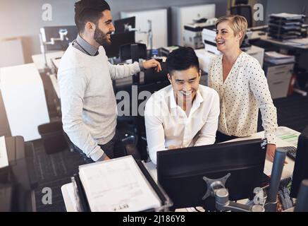 Working together gets the job done quicker. Shot of creative colleagues working together in the office. Stock Photo