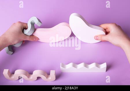 Hands with abstract geometric shapes, arranging it, playing. Concept of kids education, creative business process. High quality photo Stock Photo