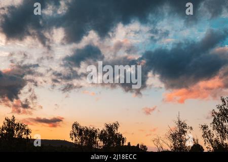 Beautiful sunset sky. Nature sky backgrounds. Multicolored sky. Tree silhouette. cloudscape at sunset Stock Photo
