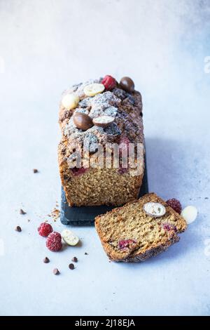 Vanilla cake with chocolates and raspberry.  Sliced, overhead view. Stock Photo