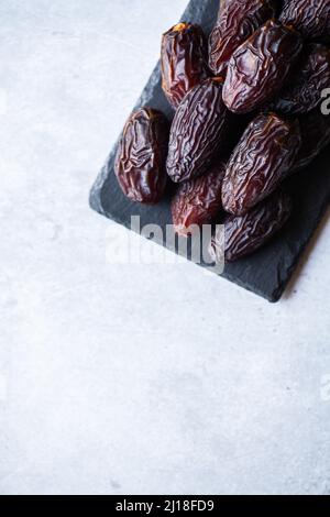 Fresh medjoul dates on a slate board. Top view and copy space. Stock Photo