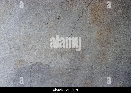 Dark gray cracked concrete plaster wall surface with rustic grunge texture Stock Photo