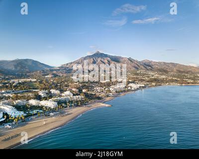 Beautiful aerial Panoramic View of Marbella, Nueva Andalucia and Puerto Banus area. Beautiful colours at sunset. La Concha mountain in background. Stock Photo