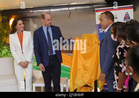 The Duke and Duchess of Cambridge and Minister of Health and Wellness, Dr. the Hon. Christopher Tufton, MP unveil a plaque during a visit to Spanish Town Hospital in Kingston, Jamaica, to meet doctors, nurses and other members of staff to hear about their experiences as part of the frontline response to COVID-19 in Jamaica, on day five of the royal tour of the Caribbean on behalf of the Queen to mark her Platinum Jubilee. Picture date: Wednesday March 23, 2022. Stock Photo