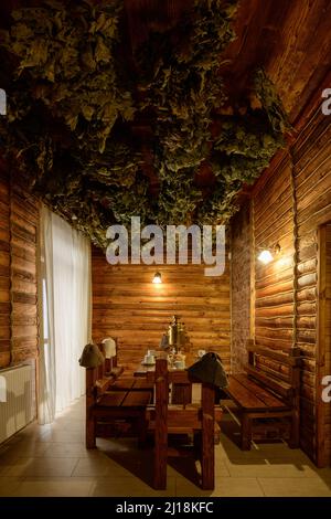 Bukovel, Ukraine February 4, 2022: bath in the Bukovel Hotel, steam treatments, wooden sunbeds and birch brooms. Stock Photo