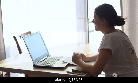 Authentic Stressful Woman working Chatting On Laptop Living Room. Writing Searching Using IT. Tired Sad Lady Working On Computer Internet On Stock Photo