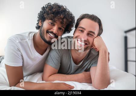 Affectionate Indian man embracing his Caucasian boyfriend Stock Photo