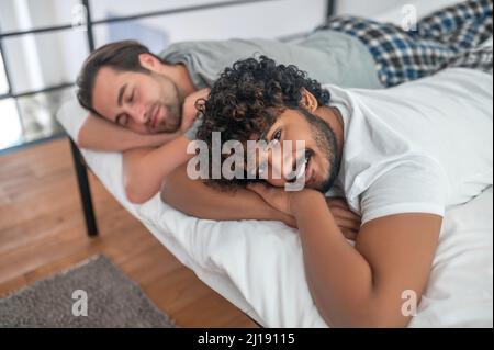 Male and his boyfriend resting in their bedroom Stock Photo