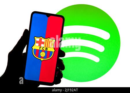 Spain. 23rd Mar, 2022. In this photo illustration a Football Club Barcelona (FCB) logo seen displayed on a smartphone with a Spotify logo in the background. (Credit Image: © Thiago Prudencio/SOPA Images via ZUMA Press Wire) Stock Photo