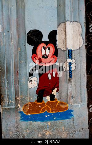 Mural drawing of Micky Mouse smiling and holding cotton candy on a street in Havana, Cuba, Stock Photo