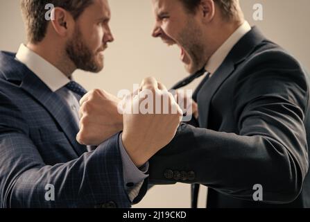 fist of punching disagreed men business partners or colleague disputing, selective focus, corporate battle. Stock Photo