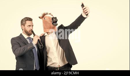 Try to hold it steady. Drunk coworkers take selfie video on smartphone. Video recording Stock Photo