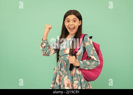 graduated. beautiful kid with long hair on blue background. september 1. happy childhood. Stock Photo