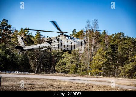 U.S. Army Chief Warrant Officer 3 Andrew Conner and Cpt. Si Yi, Apache pilots, assigned to Bravo Company, 1-3rd Attack Battalion, 12th Combat Aviation Brigade, come in for a landing at the Forward Arming and Refueling Point (FARP) at Camp Adazi, March 21, 2022. 12 CAB is among other units assigned to V Corps, America's Forward Deployed Corps in Europe that works alongside NATO Allies and regional security partners to provide combat-ready forces, execute joint and multinational training exercises, and retains command and control for all rotational and assigned units in the European Theater. (U. Stock Photo