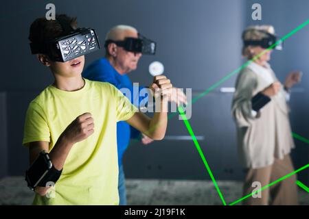 Boy playing VR games with his family Stock Photo