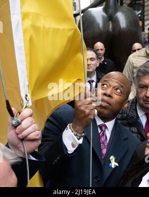 New York, USA. 23rd Mar, 2022. New York City Mayor Eric Adams raises the Ukrainian flag in Manhattan's financial district during a show of support for Ukraine against the Russian invasion. Credit: Enrique Shore/Alamy Live News Stock Photo