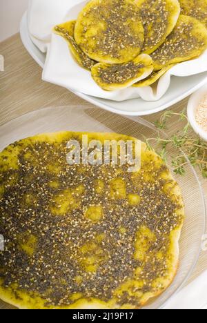 Lebanese manouche or manoushe, lebanese pizza with thyme and sesame seeds, zaatar, and extra virgin olive oil on top Stock Photo