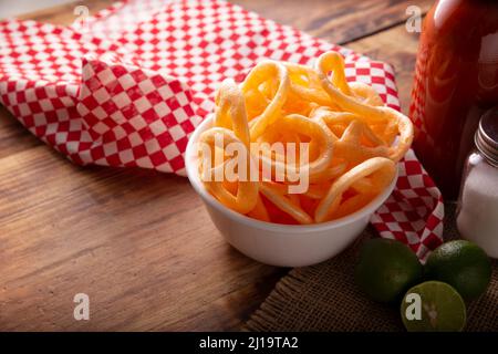 Chicharrones de Harina. Also known as duros, duritos, Mexican wagon wheels or pinwheels, they are a very popular snack made from flour, commonly accom Stock Photo