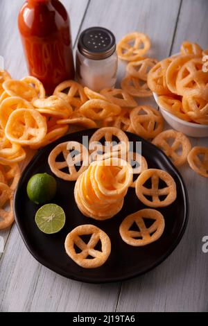 Chicharrones de Harina. Also known as duros, duritos, Mexican wagon wheels or pinwheels, they are a very popular snack made from flour, commonly accom Stock Photo