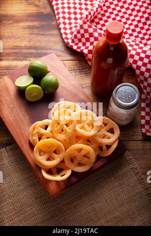 Chicharrones de Harina. Also known as duros, duritos, Mexican wagon wheels or pinwheels, they are a very popular snack made from flour, commonly accom Stock Photo