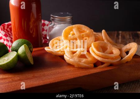 Chicharrones de Harina. Also known as duros, duritos, Mexican wagon wheels or pinwheels, they are a very popular snack made from flour, commonly accom Stock Photo