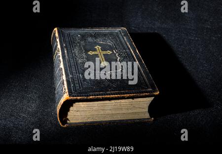 Old Bible, book on black background Stock Photo