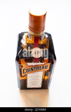 Moscow, Russia - March 20, 2022: closed bottle of french Cointreau liqueur on pale table. Cointreau is orange flavoured triple sec liqueur produced in Stock Photo