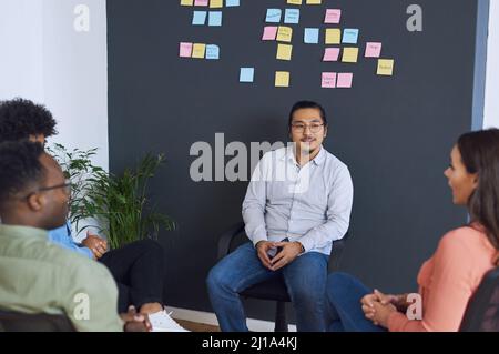 The meeting room of millennials. Shot of a team of young businesspeople having a brainstorming session in a modern office. Stock Photo
