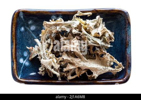 portion of dried Iceland moss (Cetraria islandica) in bowl isolated on white background Stock Photo