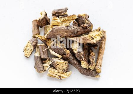 top view of pile of dried Liquorice roots on white background Stock Photo