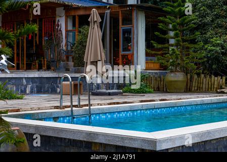 An abandoned swimming pool in an outdoor park Stock Photo