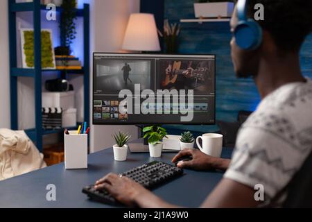 Professional videographer man working remote from home at montage film editing visual effects using post production software. Filmmaker artist designing creative content in creativity studio Stock Photo