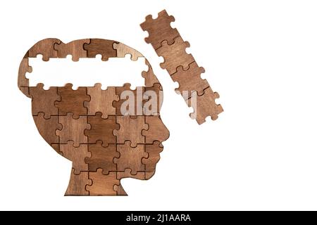 Woman's head profile shaped jigsaw puzzle with some final pieces to be set in place isolated on white. Business idea development and expertise impleme Stock Photo