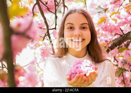 happy kid at sakura flower bloom in spring Stock Photo
