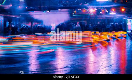 Funfair bumper cars at night in motion blur - Longtime Exposure