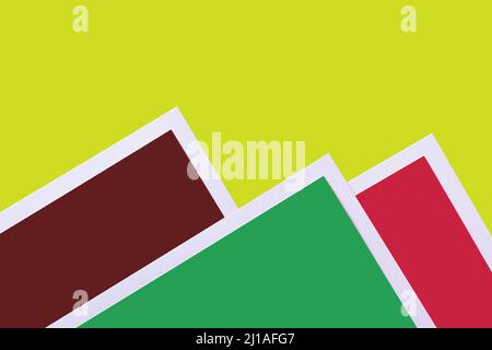 decorative mountains from colored paper on bright green background Stock Photo