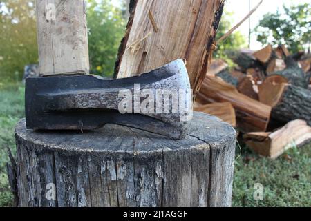 Heavy axe lies on the firewood Stock Photo