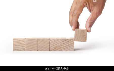 Hand putting and blank wooden cubes on isolated with white background copy space for input wording and info graphic icon. Stock Photo